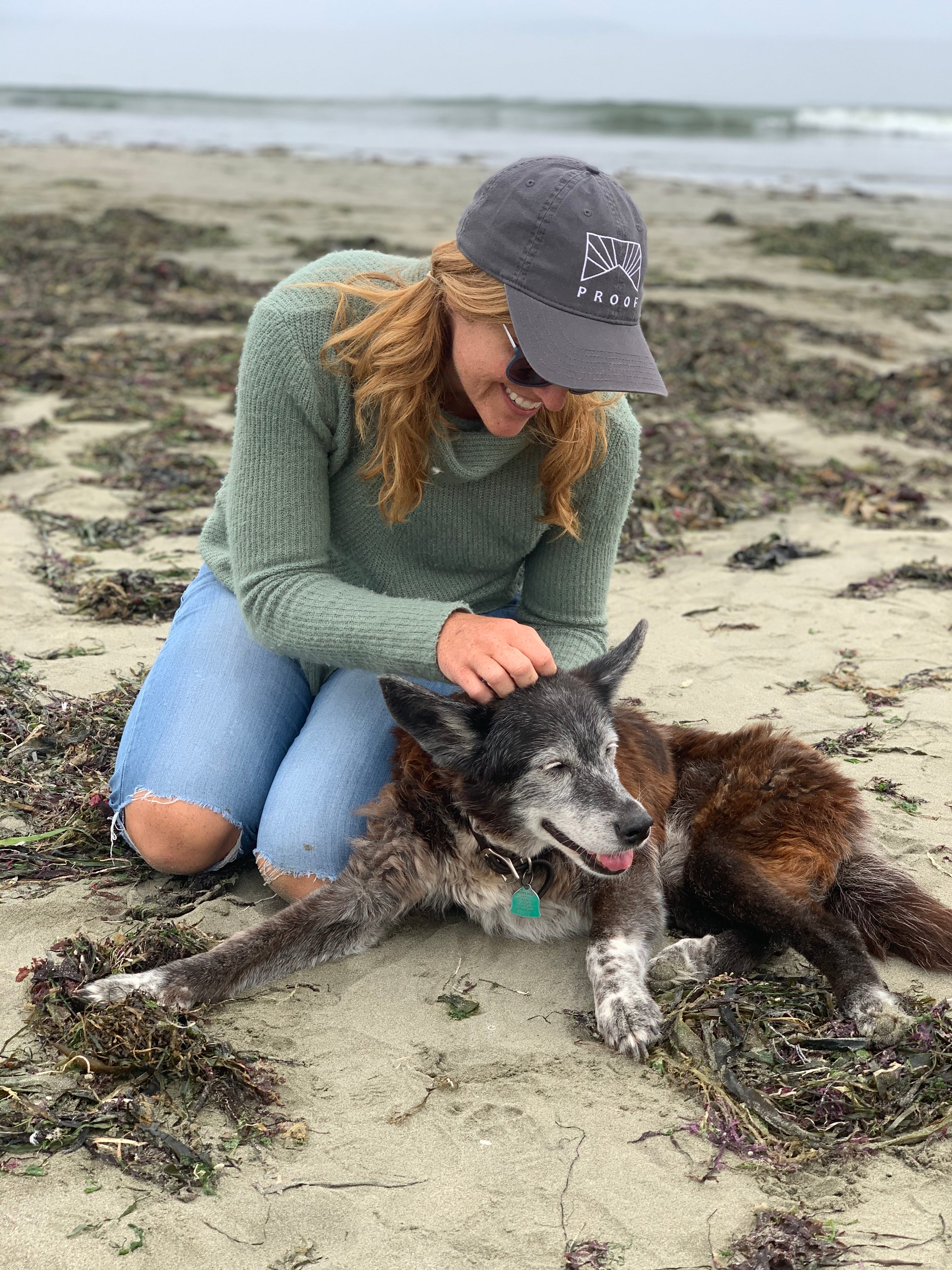 Proof founder with her old dog Vela at the beach.
